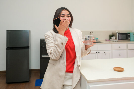 Businesswoman taking coffee break with smartphone