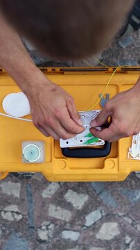 A man cutting open a fiber-optic loose tube. A man cutting open a loose buffer tube. Fiber optic splicing