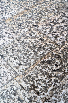 Textured granite stone surface with natural speckled pattern and diagonal crack line