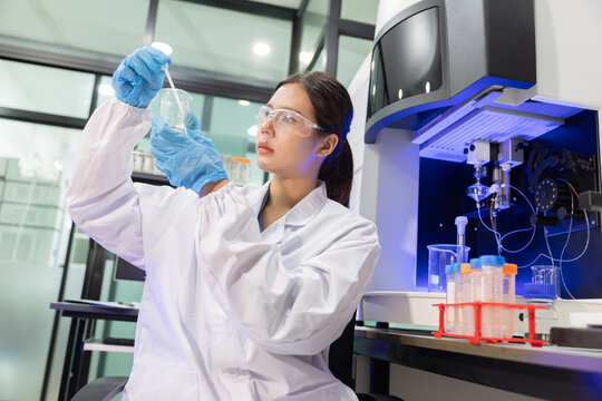 Laboratory technician conducts experiments with test tubes in a modern research facility