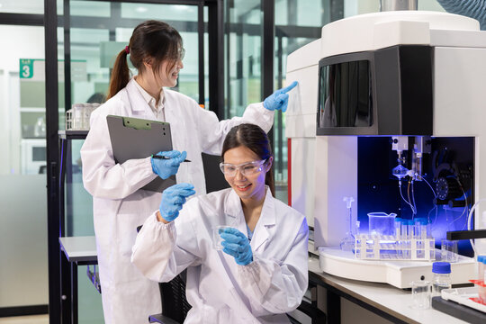 Laboratory technician conducts experiments with test tubes in a modern research facility