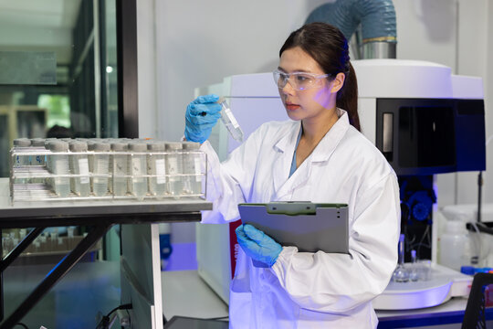 Laboratory technician conducts experiments with test tubes in a modern research facility