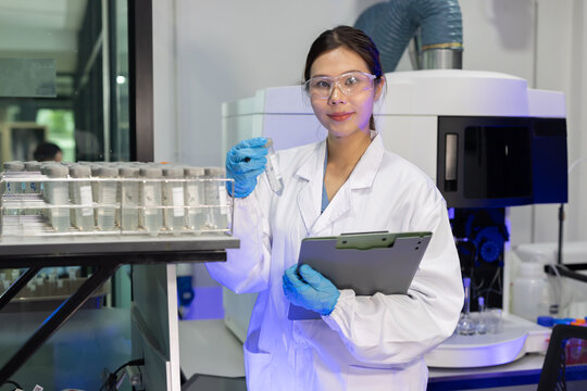 Laboratory technician conducts experiments with test tubes in a modern research facility