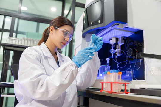 Laboratory technician conducts experiments with test tubes in a modern research facility