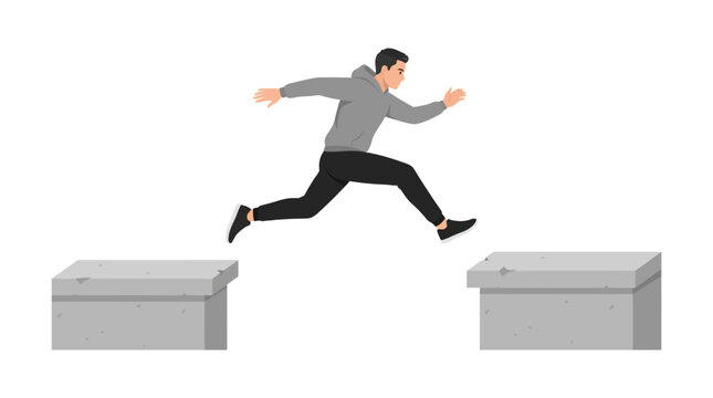 Male parkour runner jumping between urban obstacles in action
