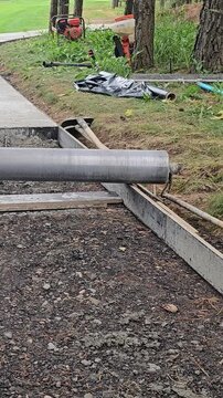 Building a pathway with concrete forms in a garden area