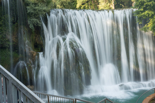 Pliva Waterfall in Jajce, Bosnia and Herzegovina surrounded by lush green forest