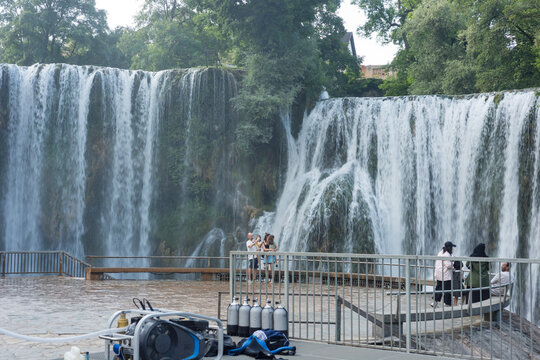 Pliva Waterfall in Jajce, Bosnia and Herzegovina surrounded by lush green forest
