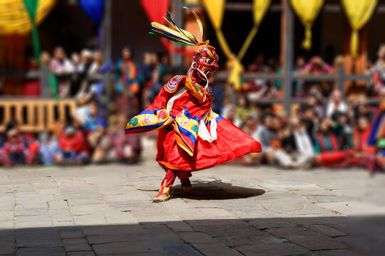 Bumthang in Bhutan at the yearly festival in the monastery of Jakar. A monk is dancing in his colourful traditional dress and mask.