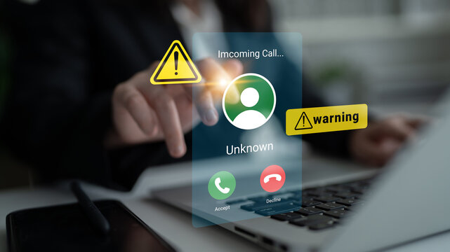 The image captures a close-up of a laptop screen displaying an incoming call alert from an unknown caller, with warning icons. It highlights modern communication risks and technology. Gantry