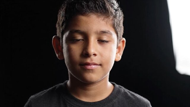 Serious Young Boy Studio Portrait on Black Background