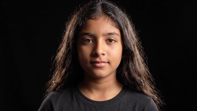Young Girl Meditating and Opening Eyes on Black Background