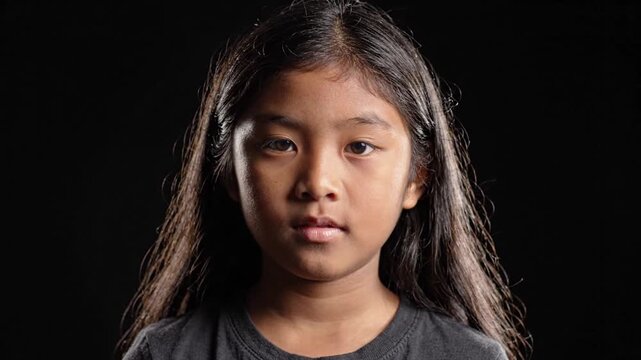 Young Asian Girl Opening Eyes on Black Background