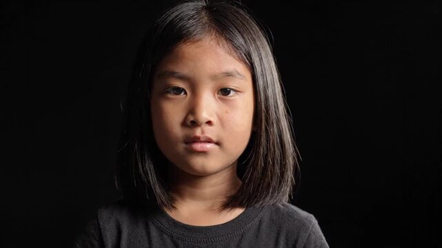 Asian Child Opening Eyes Black Background