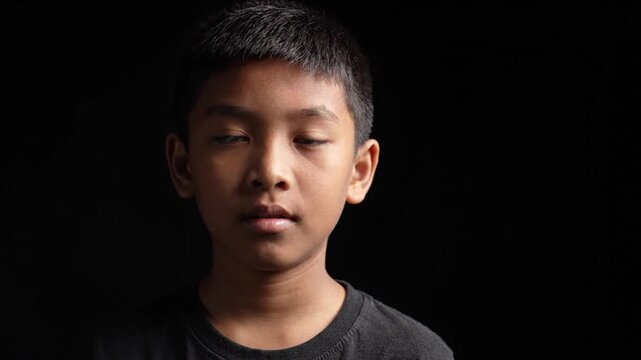 Serious Asian Boy Portrait in Dramatic Low Key Lighting