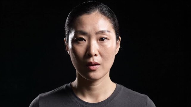 Asian Woman Meditating and Breathing on Black Background