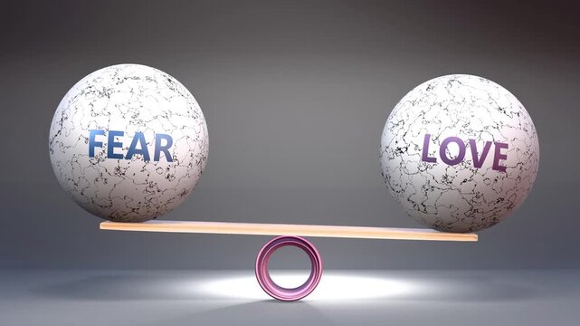 Fear and love in balance - balancing stones on a scale symbolizing harmony, equity and equilibrium between fear and love. Harmonious and beneficial situation.