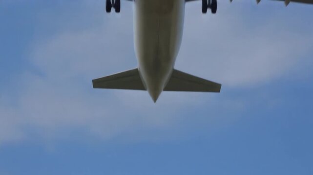 Commercial airplane taking off from airport runway against a clear blue sky
