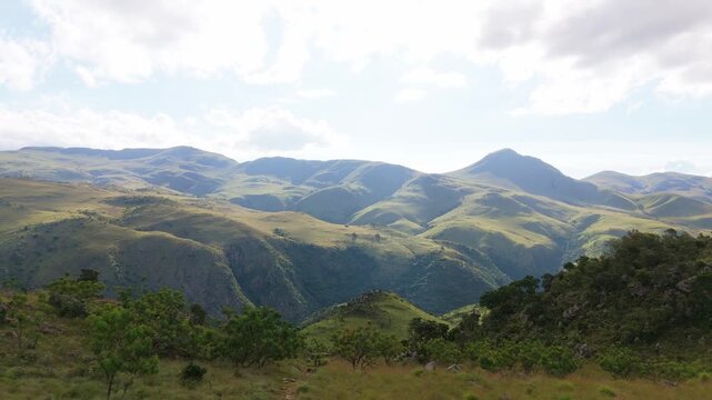 Drone video gliding laterally over Swaziland&rsquo;s unreal mountain scenery in warm evening light. Captures dramatic peaks, lush terrain, and cinematic atmosphere for editorial projects, travel features, a