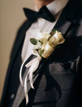 Groom Wearing Black Suit with Cream Rose Wedding Boutonniere
