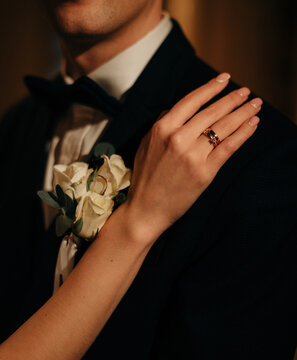Bride's Hand with Wedding Ring on Groom's Shoulder