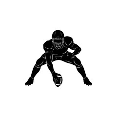 American football player in black uniform tackling opponent during intense game action