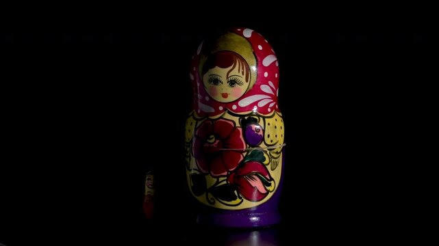 Spinning Matryoshka dolls on black background