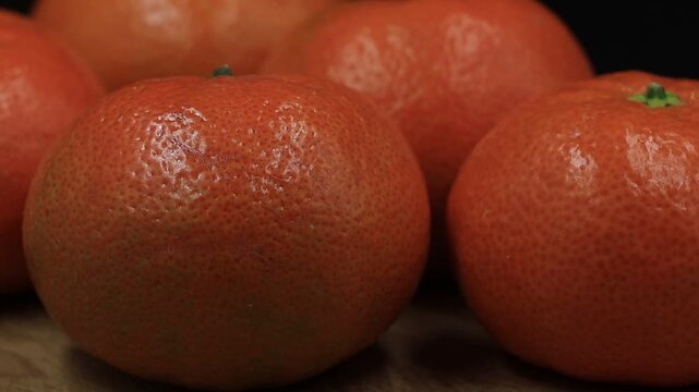 Rotating mandarin oranges close up.