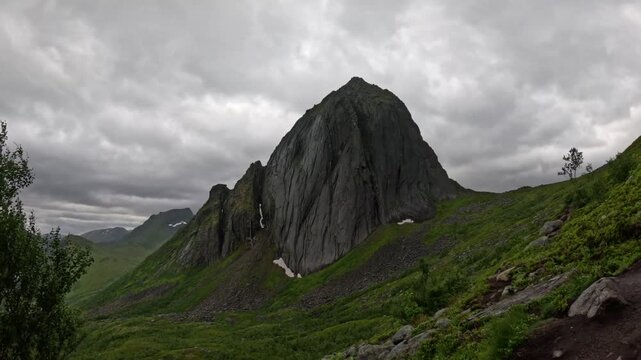 View of Segla mountain peak with hiking trail and birch trees in Senja Norway