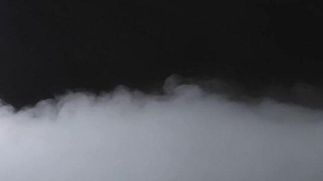 White dense fog flowing over a dark background