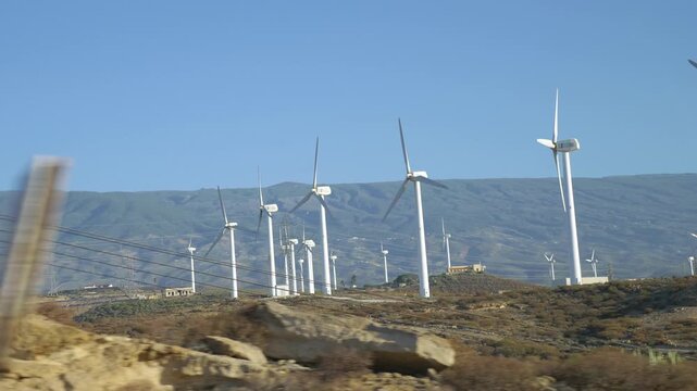 A view from a moving car of a wind farm in Gran Canaria in Spain in 4k slow motion 60fps