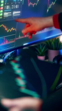 Trader Pointing Crypto Stock Market Chart Screen Technical Analysis. Over the shoulder view of financial analyst pointing finger at candlestick chart on large screen display during technical market\