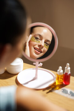 Woman Applying Eye Patches for Skin Care