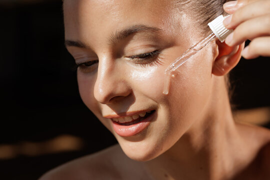 Woman Applying Facial Serum for Radiant Skin