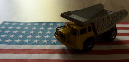 Naklejka premium toy military car on US flag. Background of war funding and military support United States