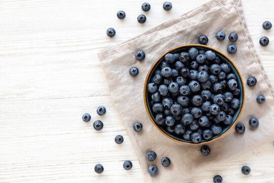 Healthy Organic Raw Blueberries in a Bowl, top view. Copy space.