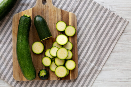 Raw Green Organic Zucchini on a Wooden Board, top view. Copy space.