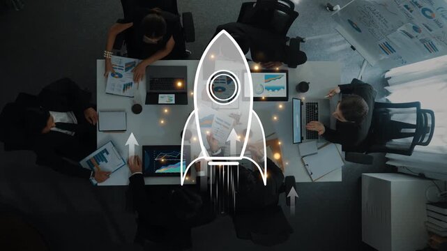 A dynamic business team engaged in a strategic meeting in an office setting, highlighting innovation and growth with visuals of charts and a rocket symbol representing aspirations. Raster