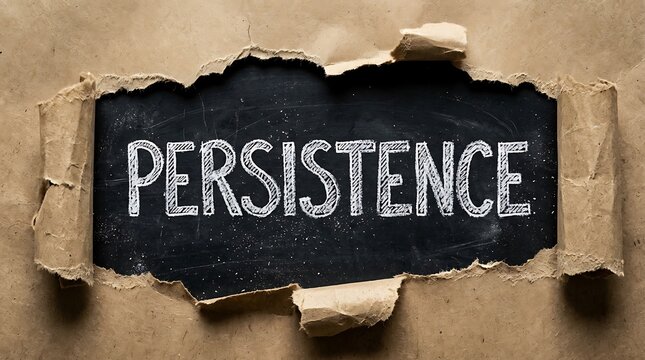 The word persistence written in white chalk on a black chalkboard revealed through torn brown paper