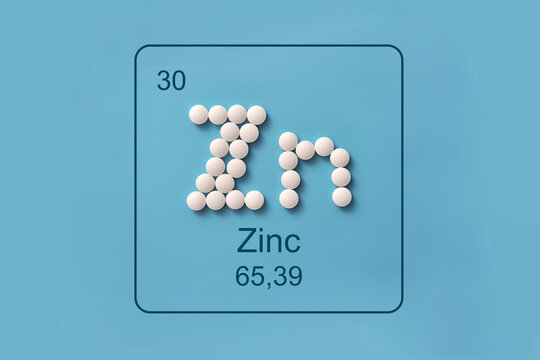Zinc Zn Element Symbol Made from White Pills on Blue Background