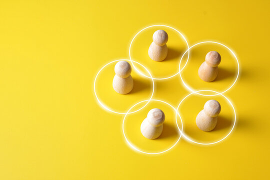 Social Connections and Community Concept with Wooden Figures in Circles