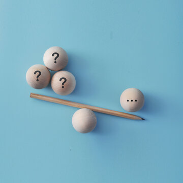 Questions and Decision Making Concept with Question Marks and Balance Scale