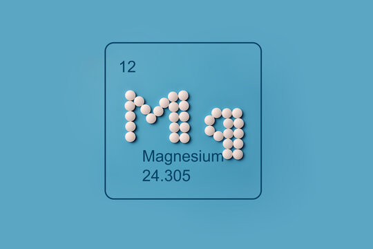 Magnesium Mg Symbol Made from White Pills on Blue Background