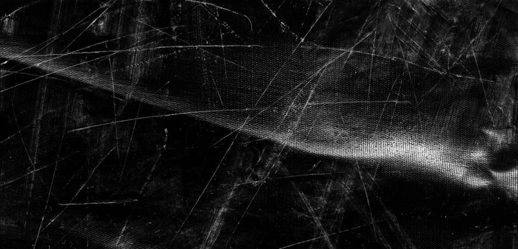 Black distressed texture with white scratch marks and fabric mesh details for edgy grunge background design.
