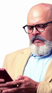 An IndAn Indian Asian senior businessman with a beard is standing against a white background  