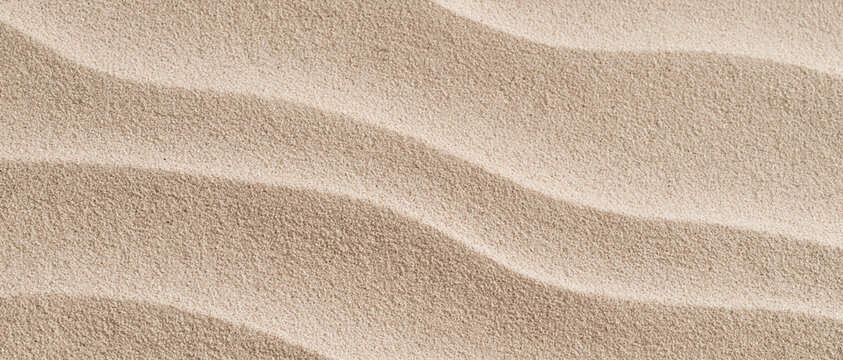 Textured beige sand dune ripples close-up background
