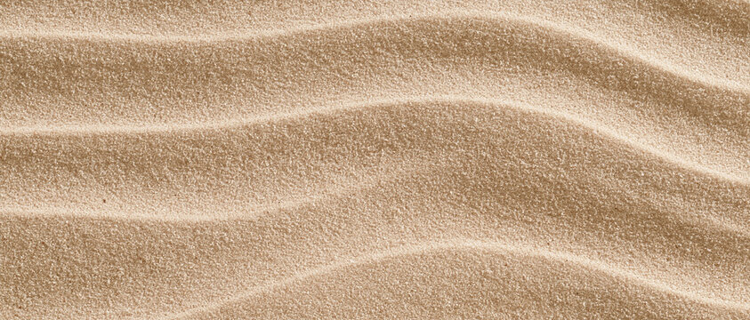 Rippled beach sand texture in beige and light brown tones, natural coastal backdrop with copy space