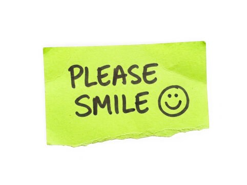 Bright green sticky note with please smile text and a happy face drawing