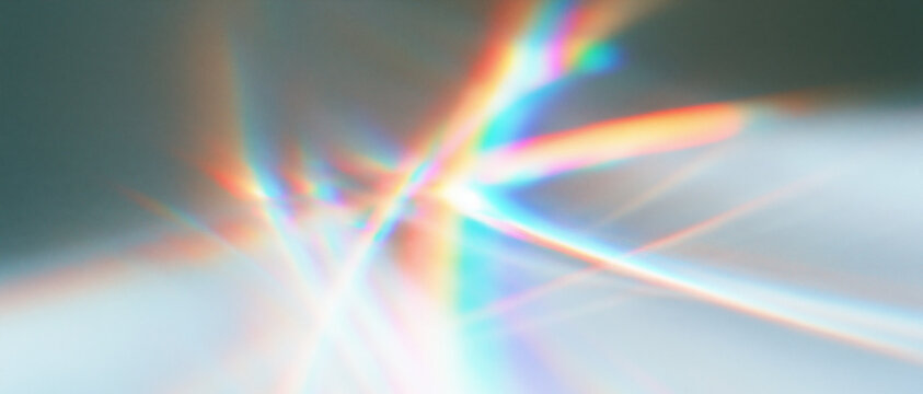 Translucent rainbow rays glowing on soft white surface