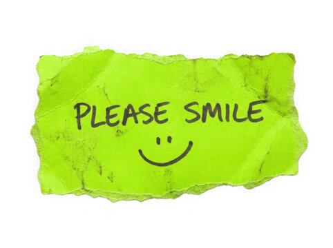 Bright green torn paper note with the text please smile and a happy face icon